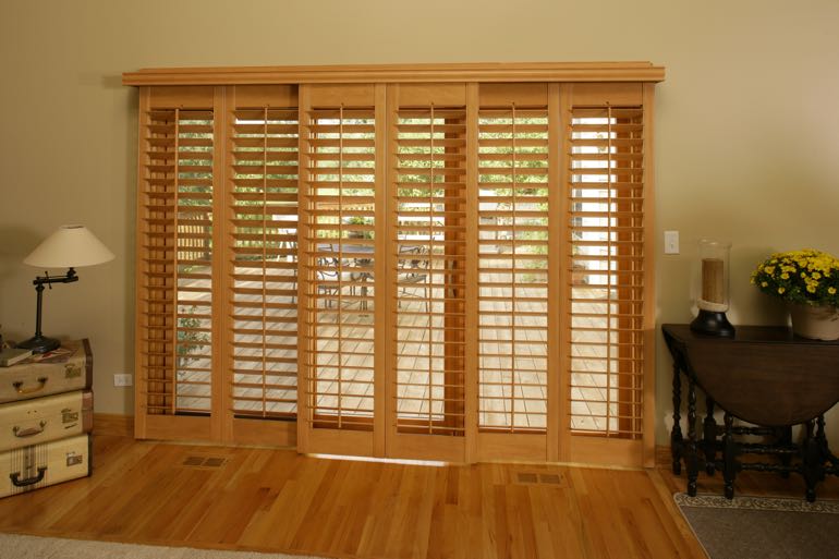 Wood shutters on sliding door going to back porch.